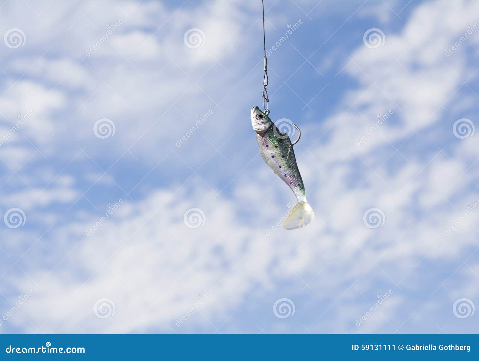 fish bait with hook against a blue summer sky.