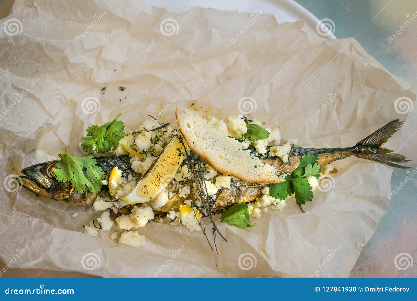 Fish Baked in Parchment with Cheese, Herbs and Lemon. Stock Photo