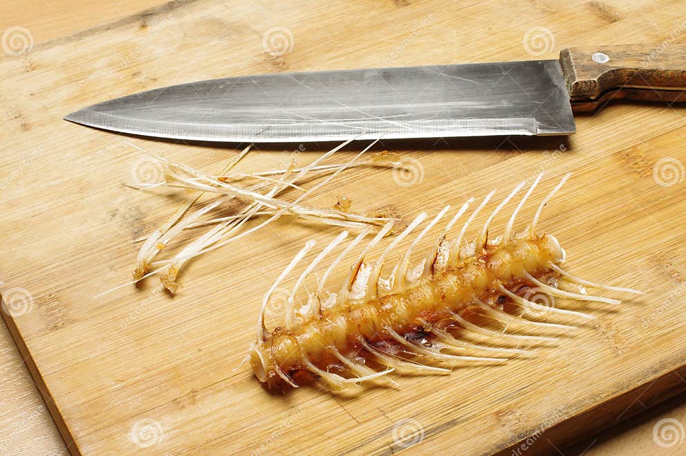 Fish Bones, Skeleton and Knife on the Cutting Table Stock Photo Image