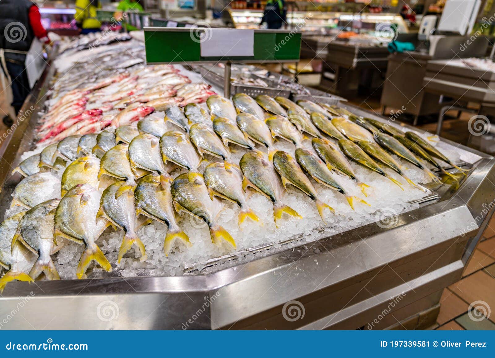 fish displayed on ice at supermarket seafood aisle