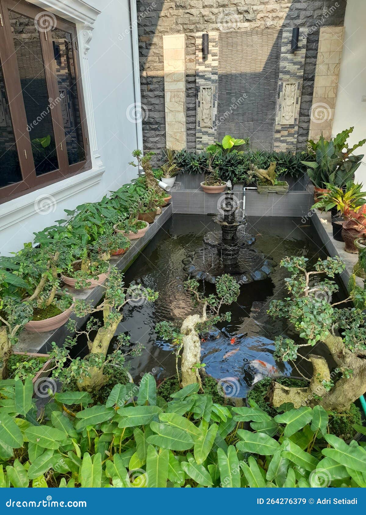 Fish pond decoration stock image. Image of property 264276379