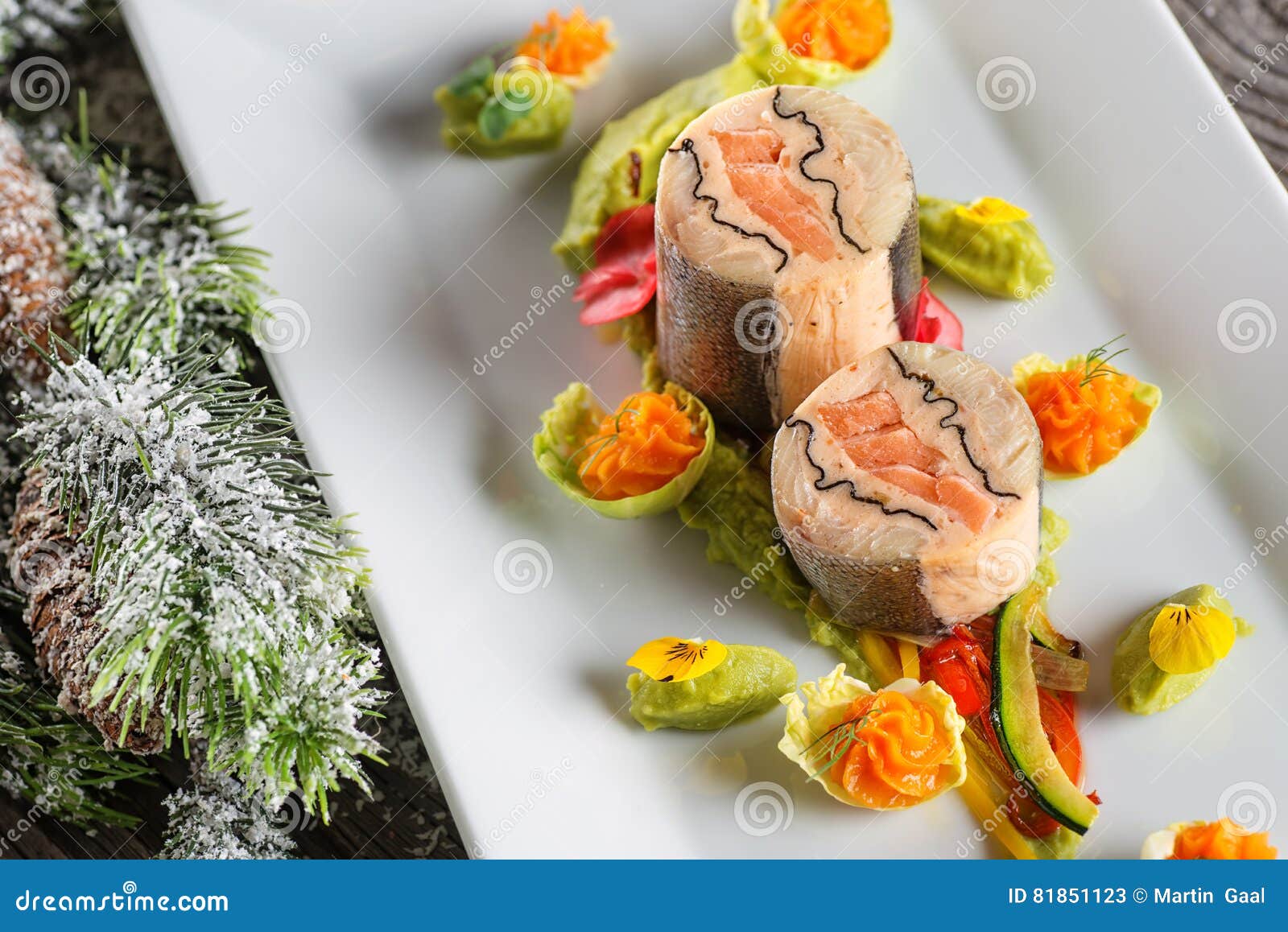fish starter food on white plate with christmas decoration. product photography and modern gastronomy