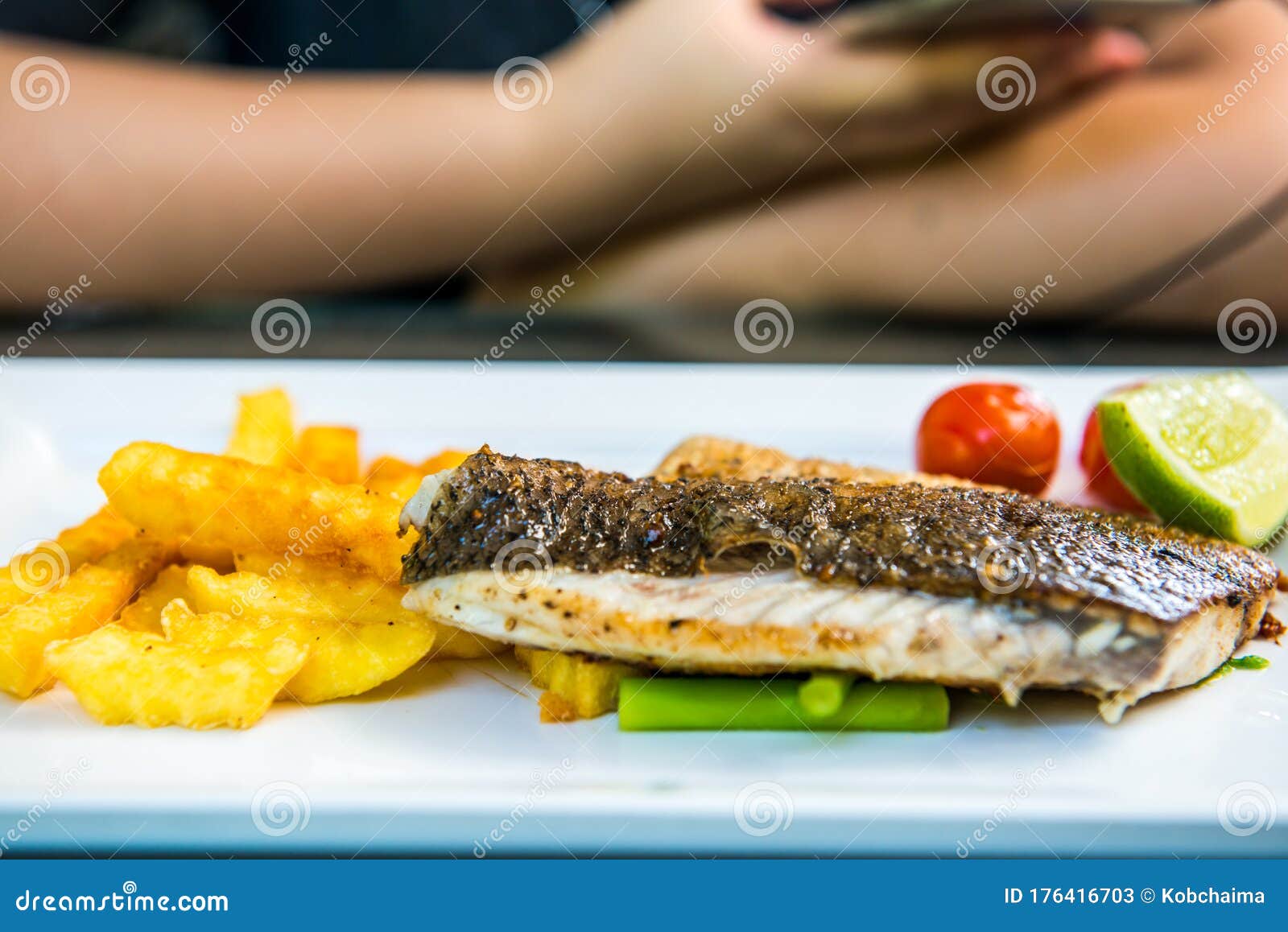 Fish steak on white plate stock image. Image of dining 176416703