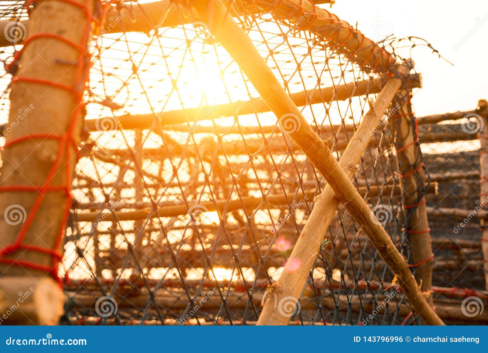 Big Fish Trap on the Quay Near the Sea with Sunset Stock Photo