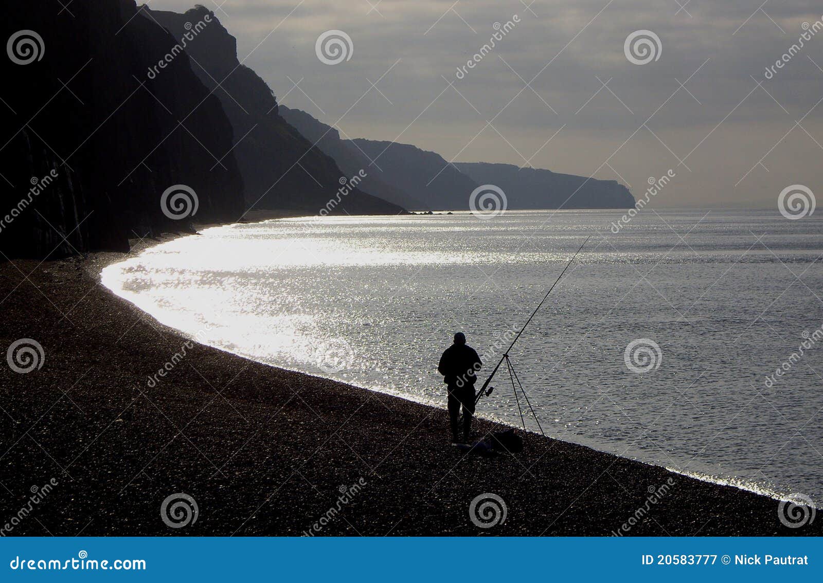 fisherman angling on beach