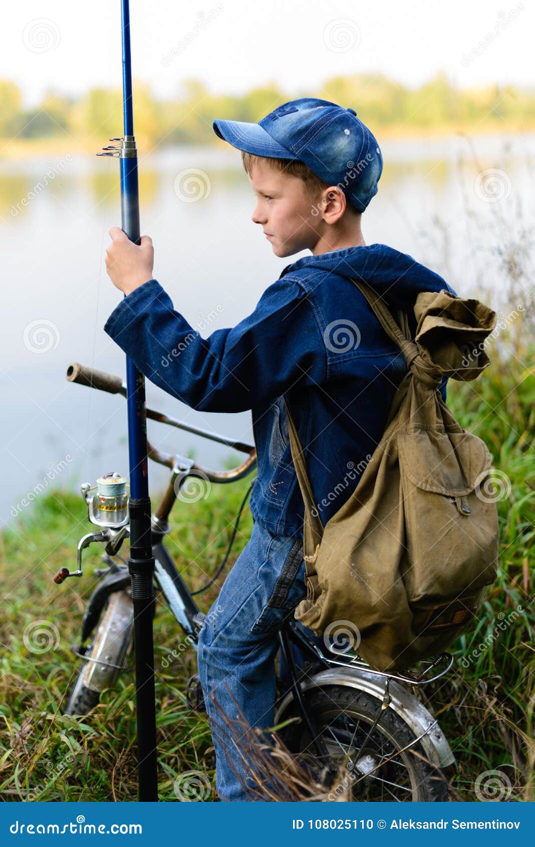 A Fisherman Boy on the River Bank with a Fishing Rod in His Hand Stock  Photo - Image of fishing, bike: 108025110