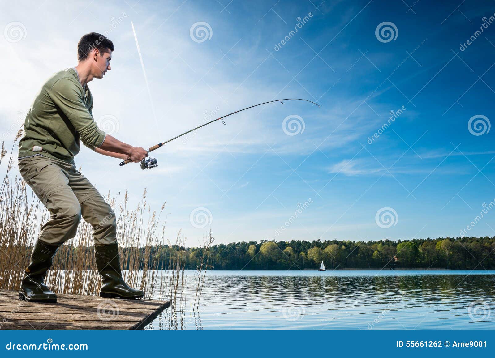 fisherman catching fish angling at the lake