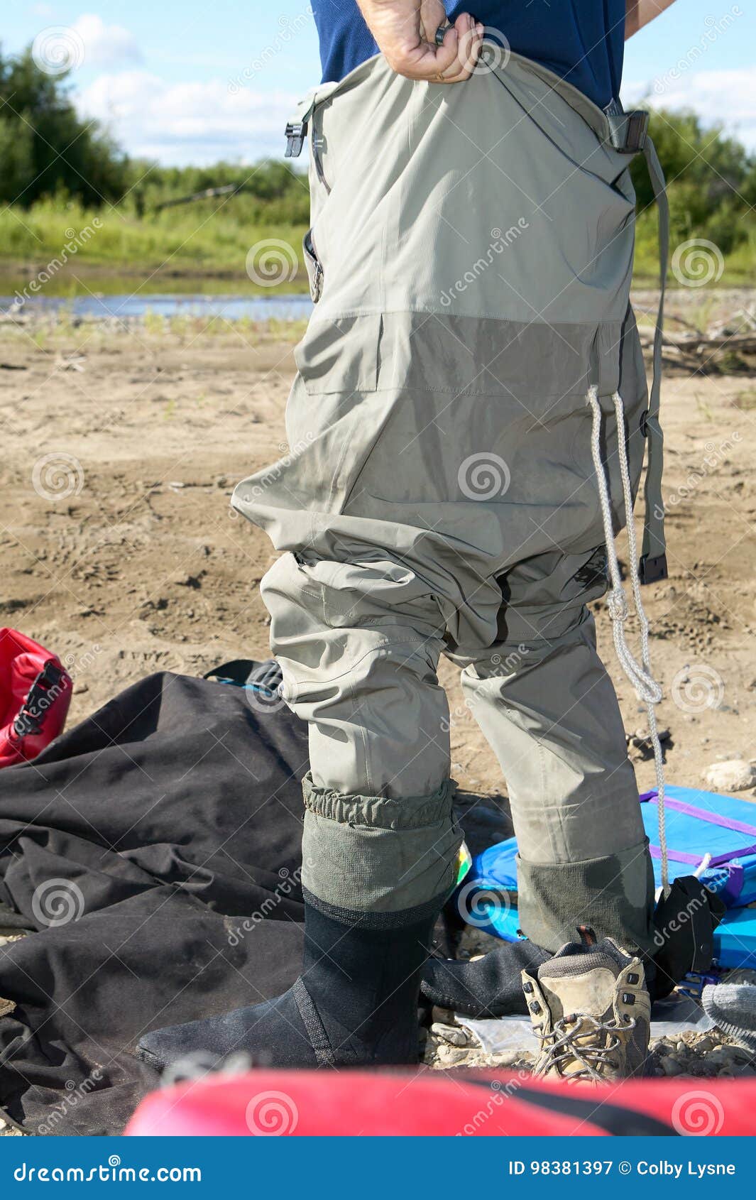 fisherman donning a pair of waders