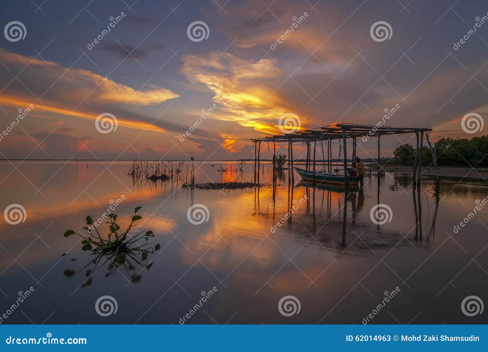 fisherman at garaje boat during sunrise at jubakar, tumpat kelantan