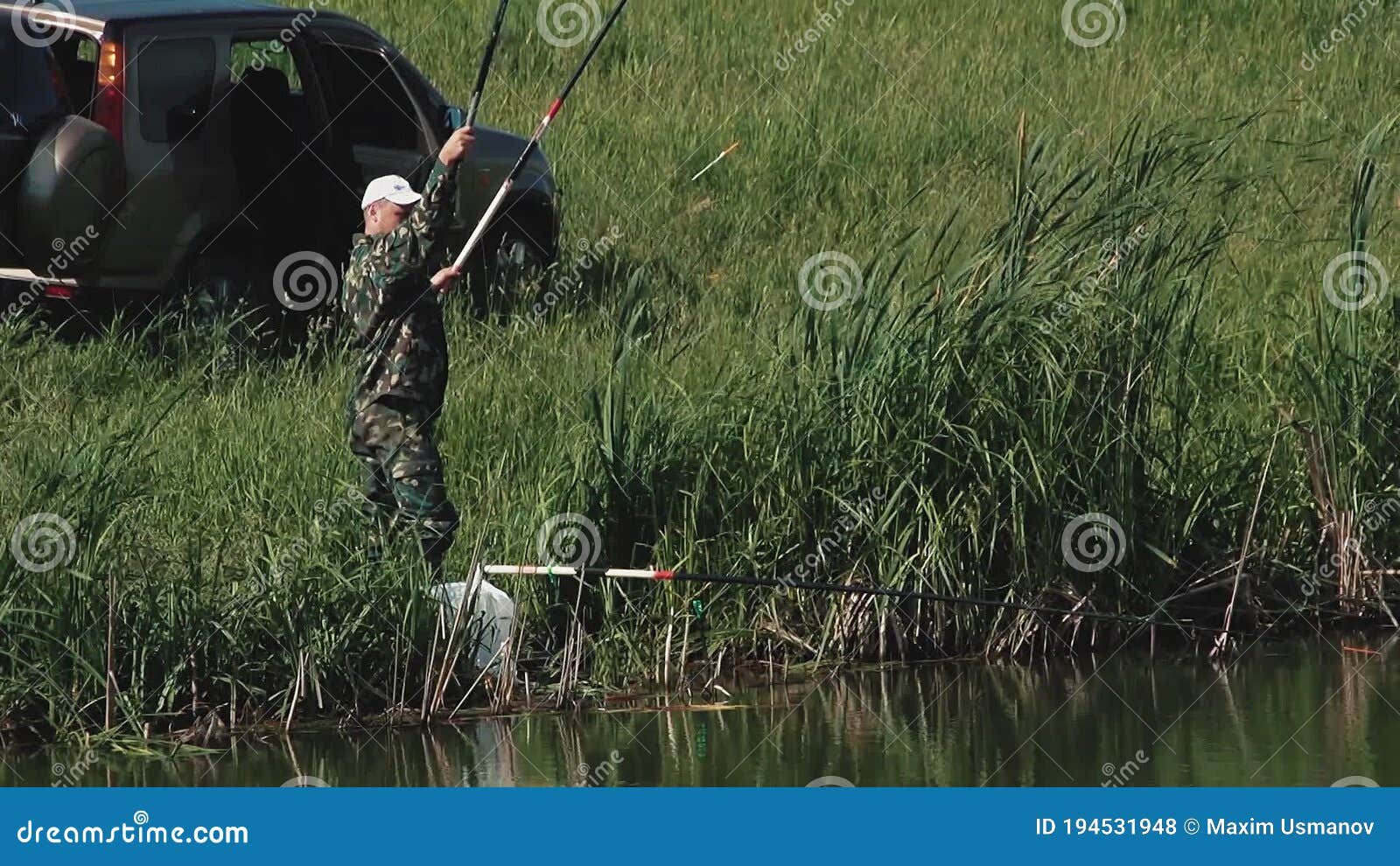 Fisherman Pulls Out the Fishing Rod with the Fish Stock Footage