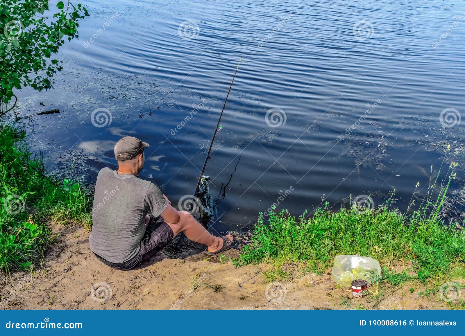 Fisherman Sitting on the Ground Fishing in a Pond - Top View. Young Adult  Man with Fishing Rod Fishing from the Shore on a Stock Photo - Image of  fish, copy: 190008616