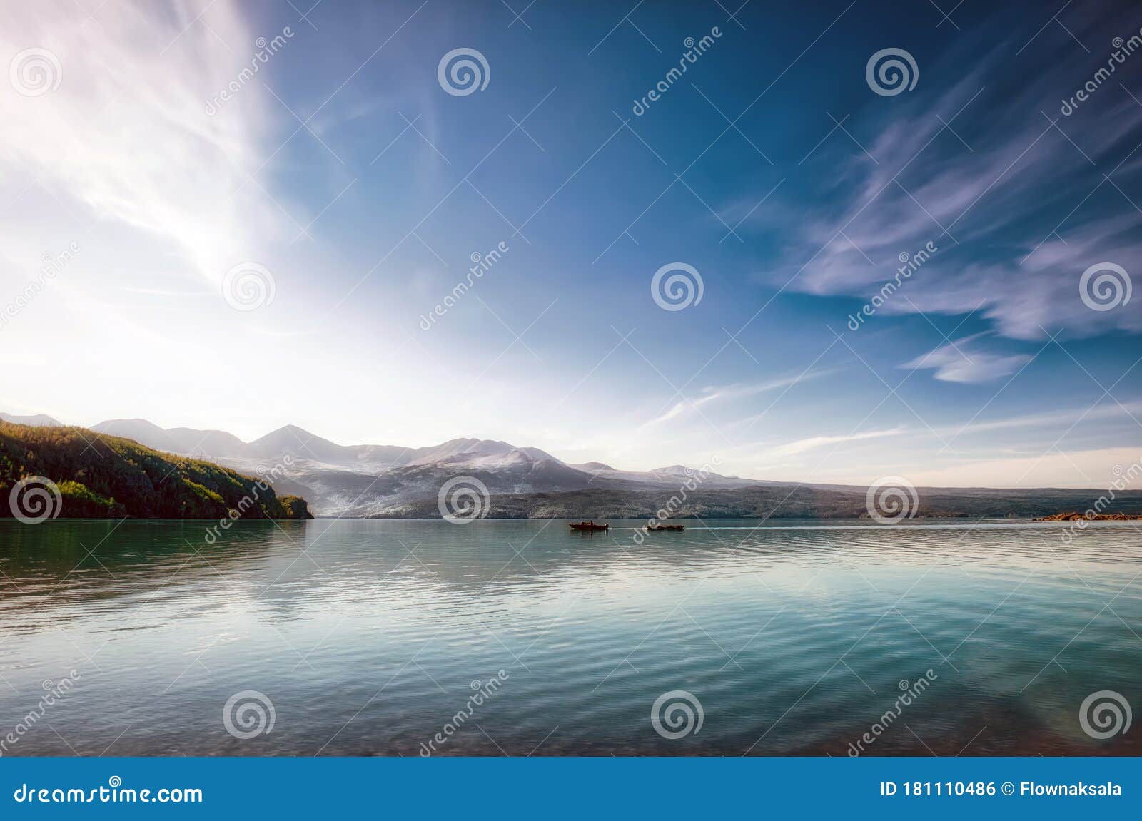 fisherman in a small boat on a beautiful pristine alaskan lake during summer