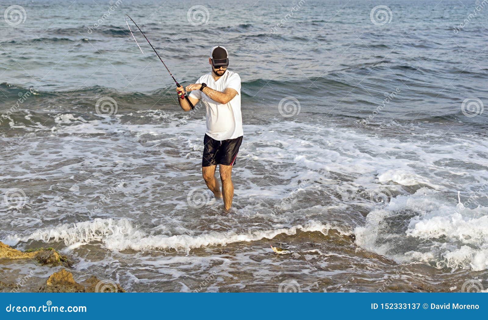 Fisherman Standing at the Seashore Hooks a Fish. Editorial Photography -  Image of beach, landscape: 152333137