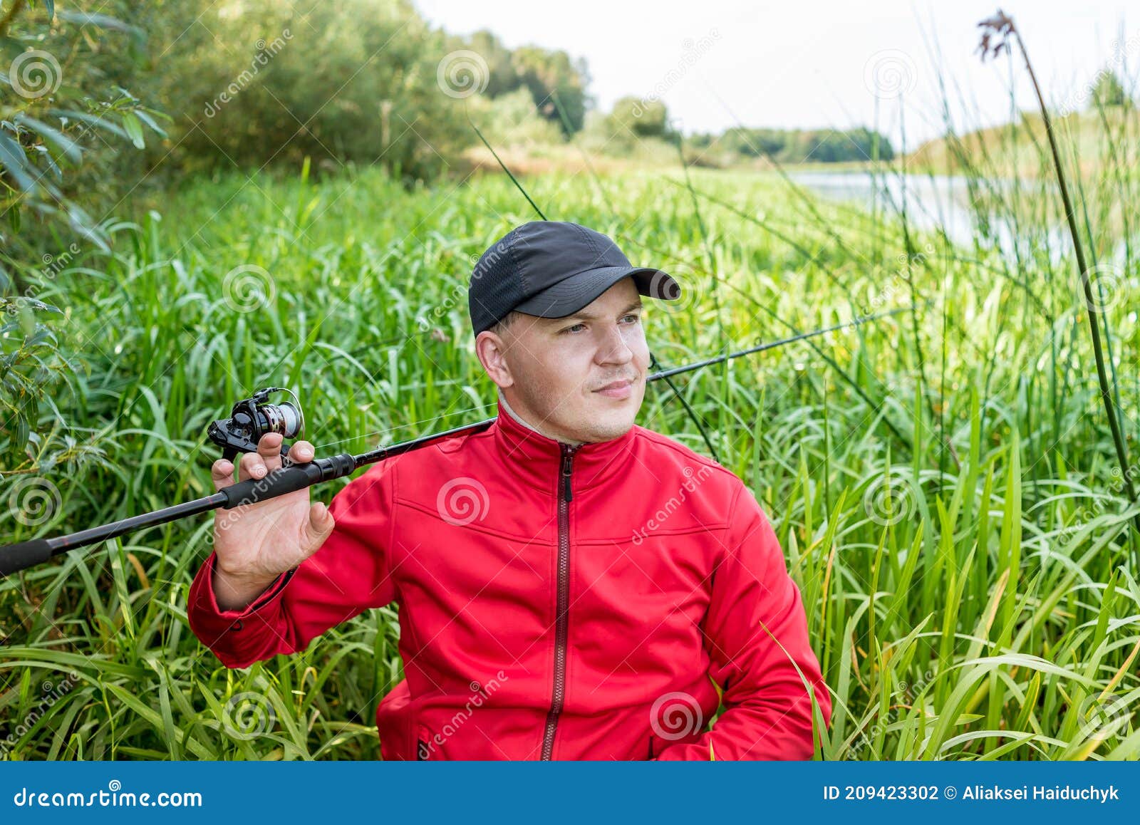 Fisherman in the Thickets of Reeds on the River Bank. Spinning Player ...