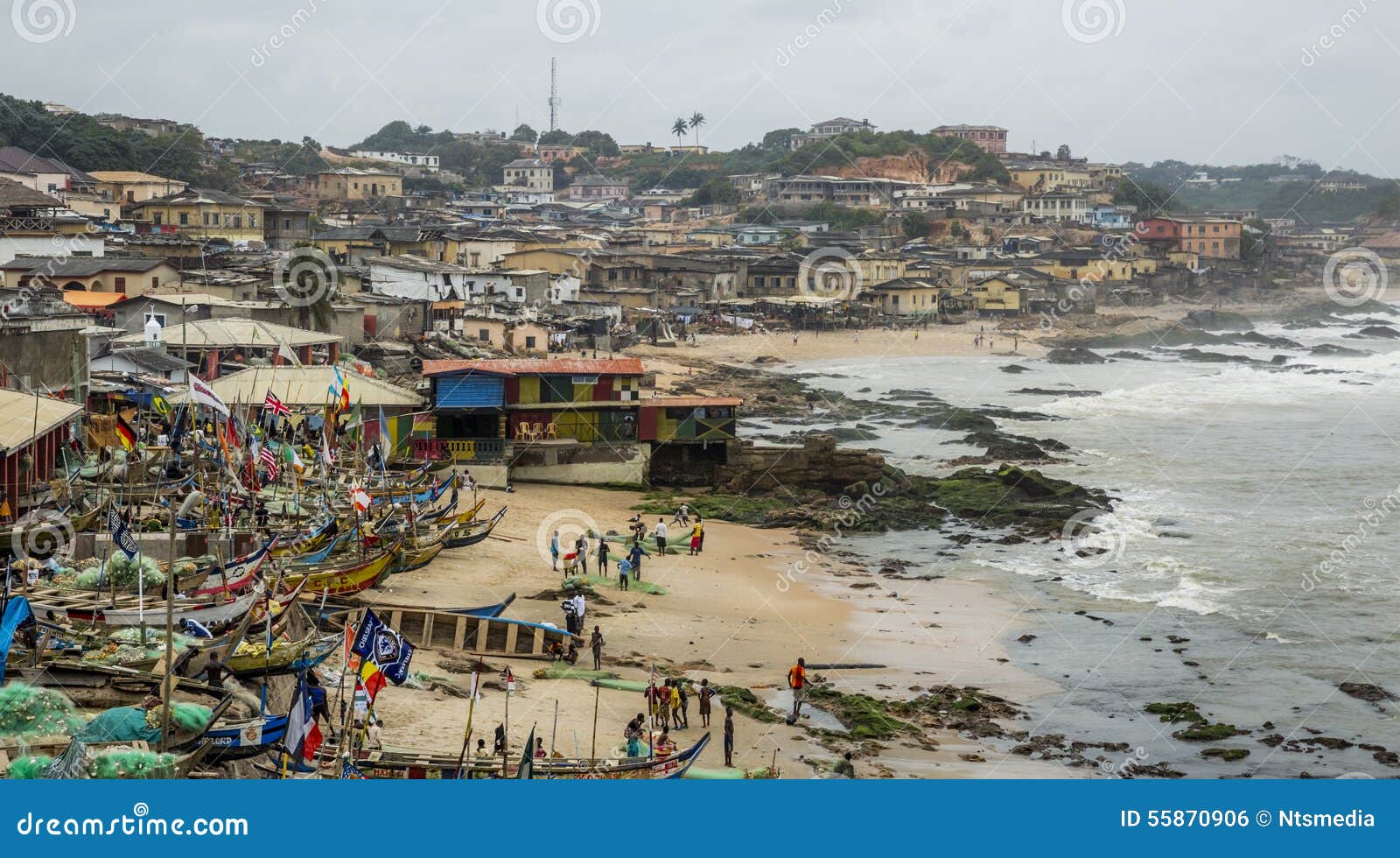 Cape Coast, Ghana - July 31, 2014: Fisherman village in Ghana, near to the Cape Coast. Traditional Ghanian fisherman boats parked at the small bay. Photo was taken from the Cape Coast Castle.