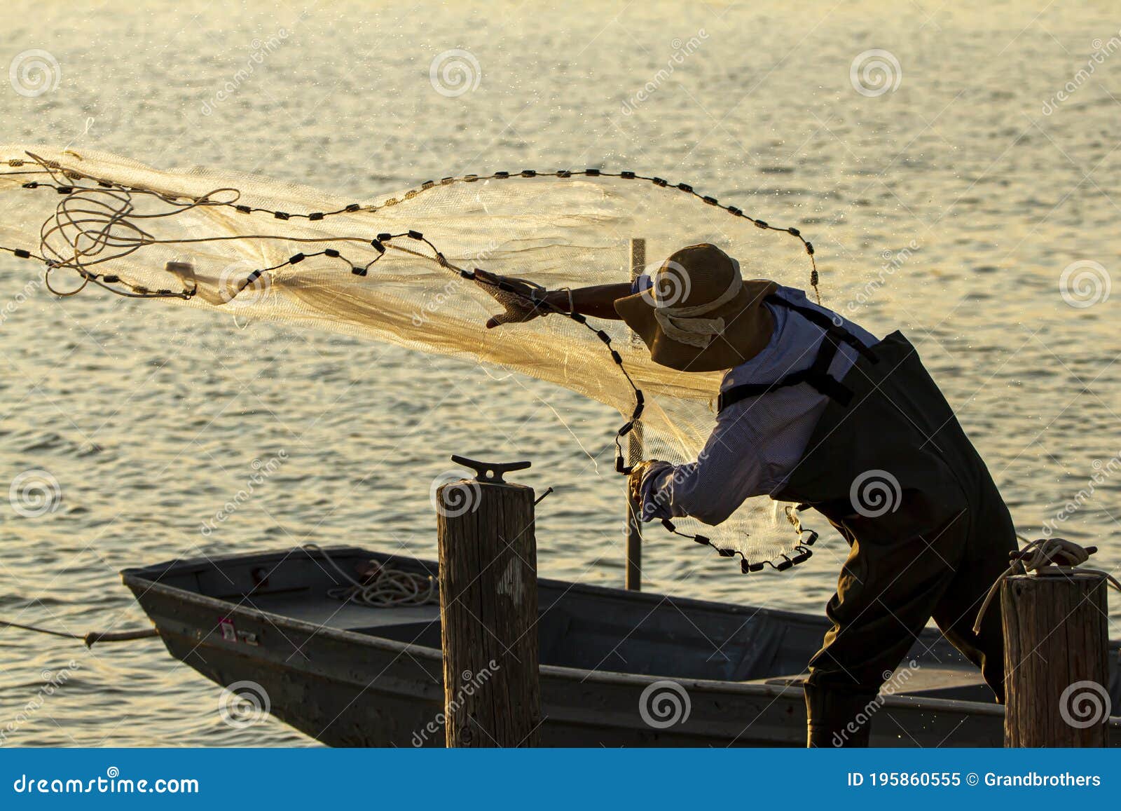 A Fisherman Casting a Fishing Net Stock Image - Image of carrying