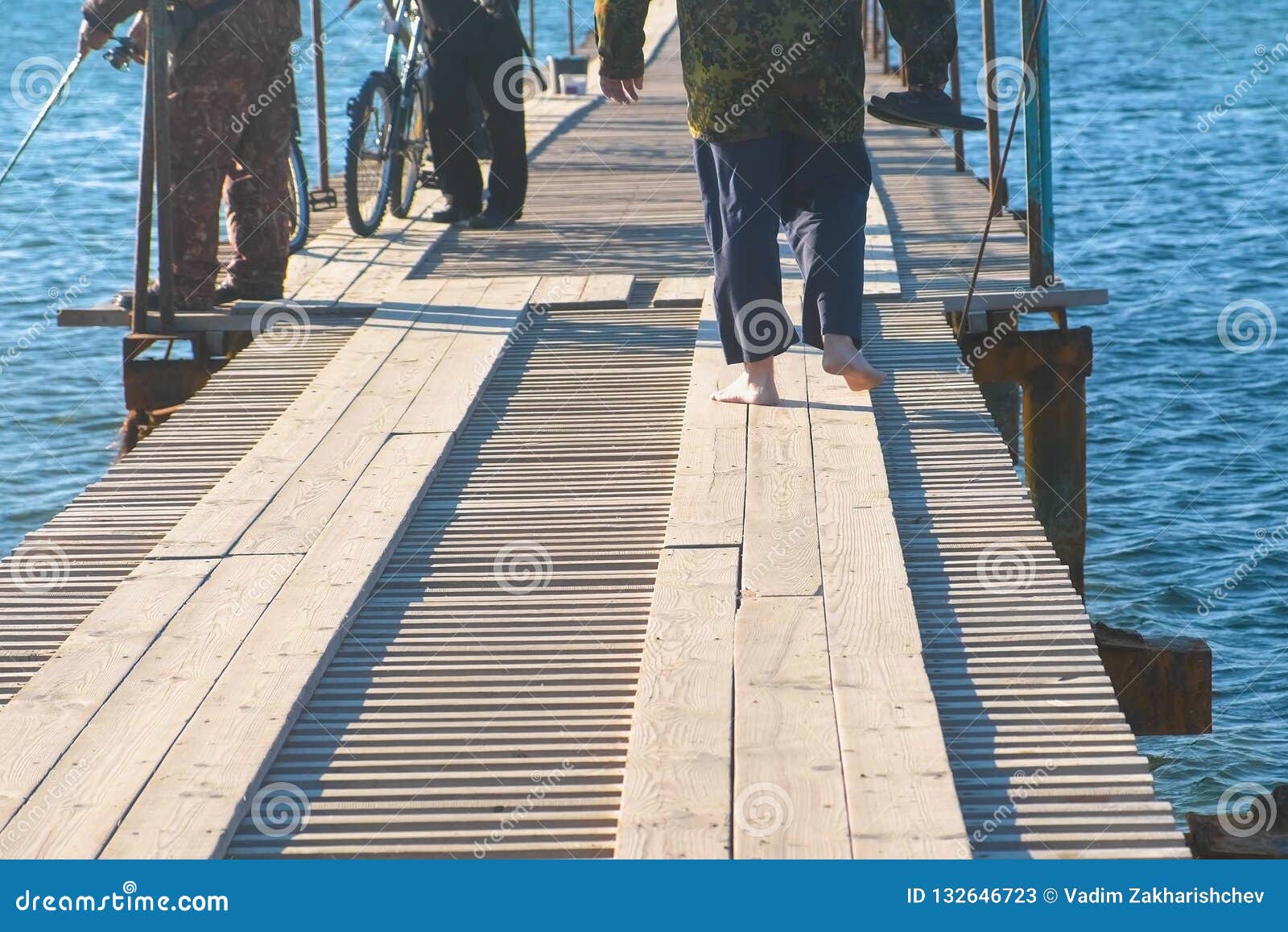 Fishermen with Fishing Rods on a Wooden Pier Coastal Sea Town. Stock ...