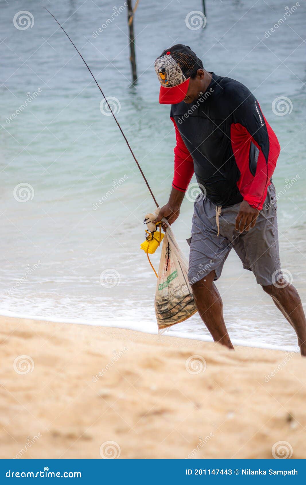 Fishermen Walking on the Beach with a Bag Full of Fish with Head Down after  Stilt Fishing Editorial Stock Photo - Image of colorful, closeup: 201147443