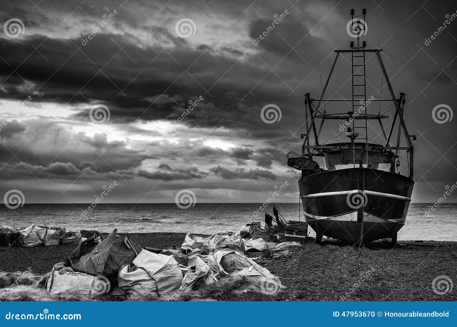 fishing boat on beach landscape with stormy sky black and