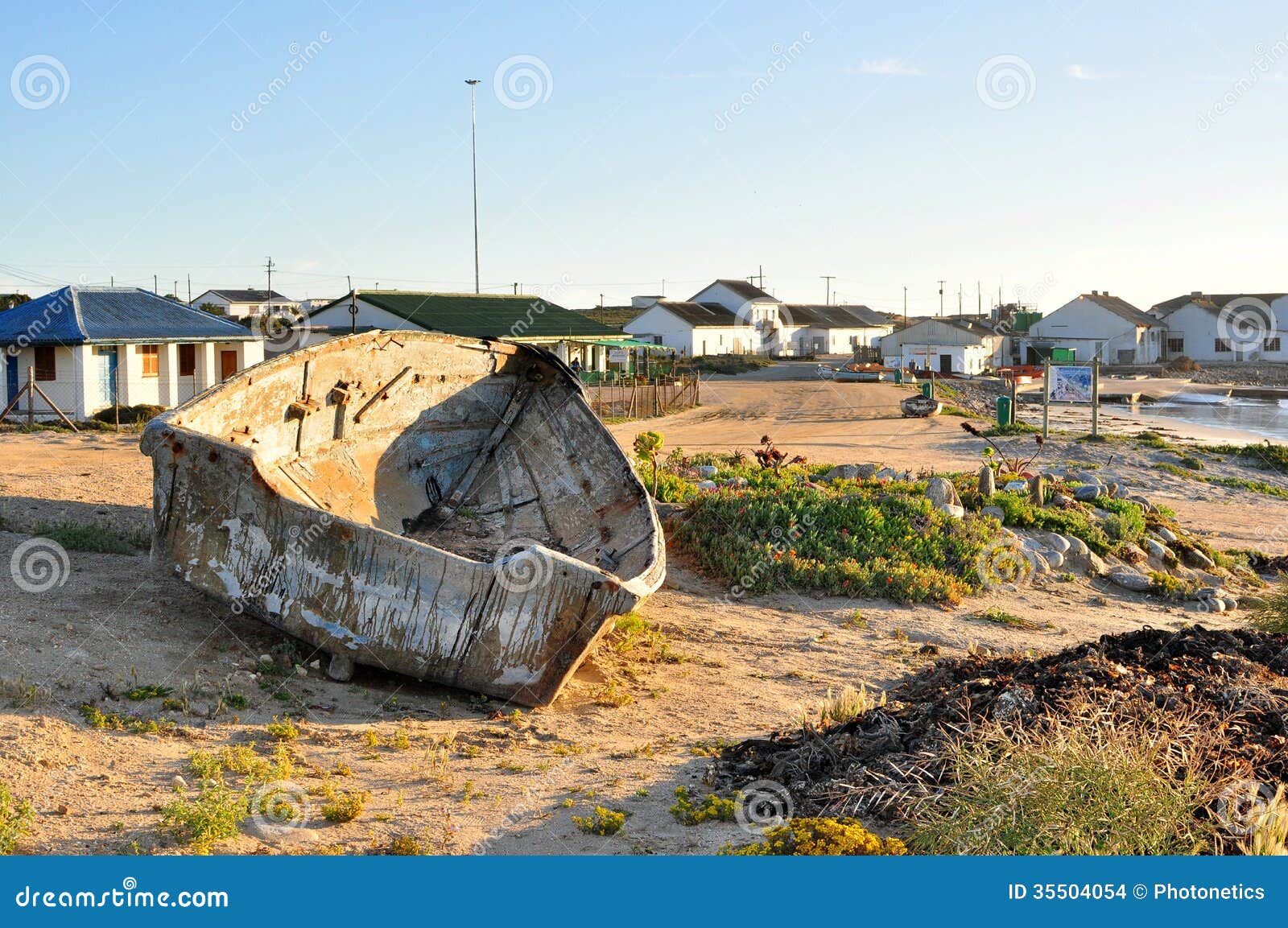 Fishing Boat With Fishing Village In Background Stock 