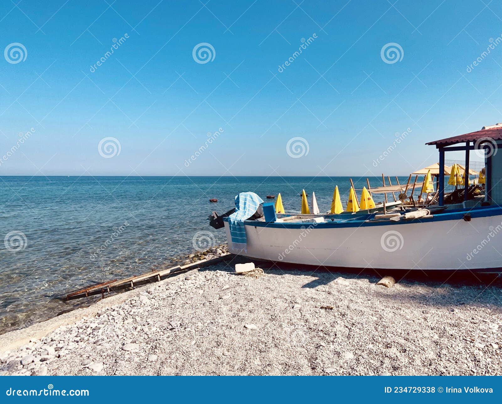 Fishing Boat Longboat on Sandy Pebbles on the Beach with Yellow