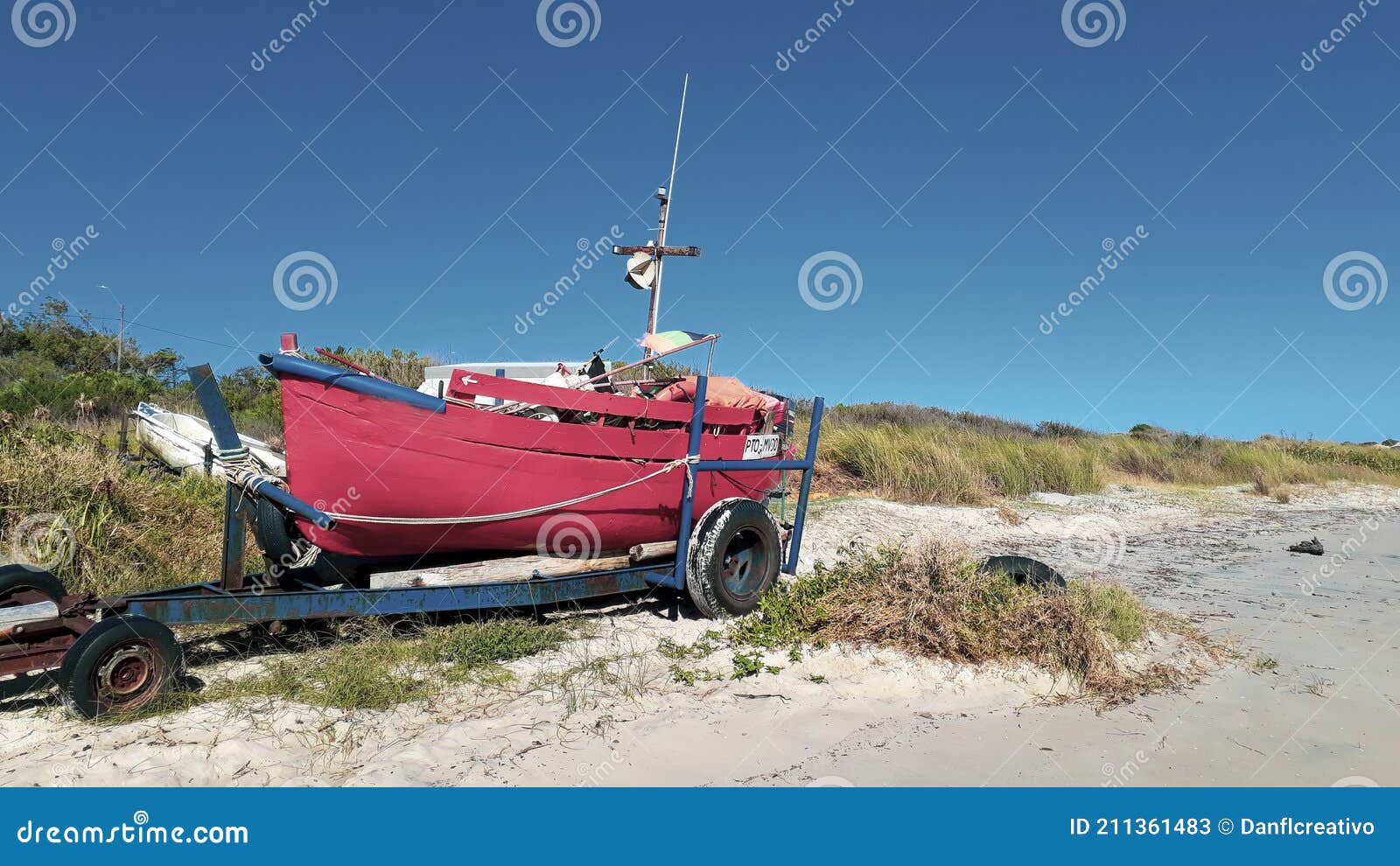 fishing boat parked at sand
