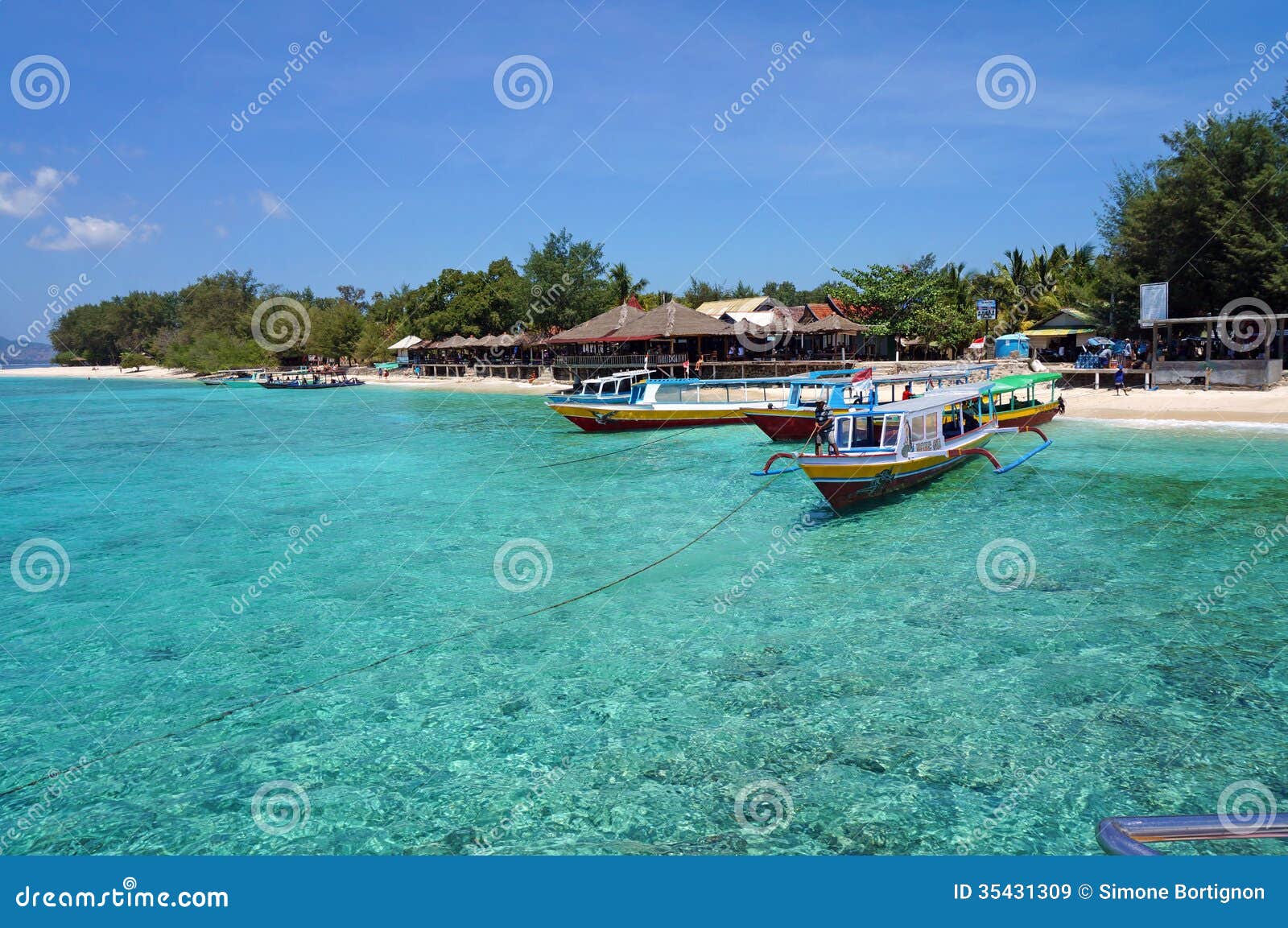 fishing boats on crystal clear turquoise water
