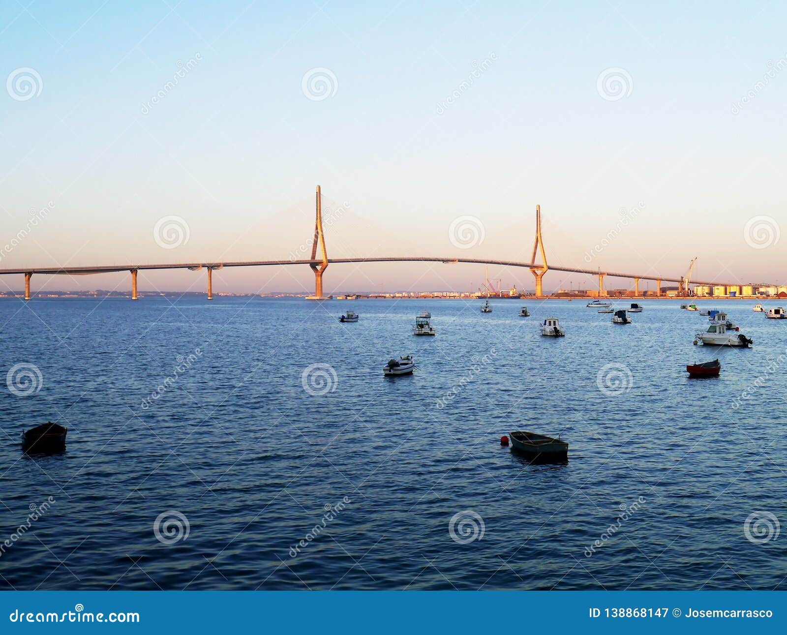 fishing boats in sunset at the puente de la constituciÃÂ³n, called la pepa, in the bay of cÃÂ¡diz, andalusia. spain