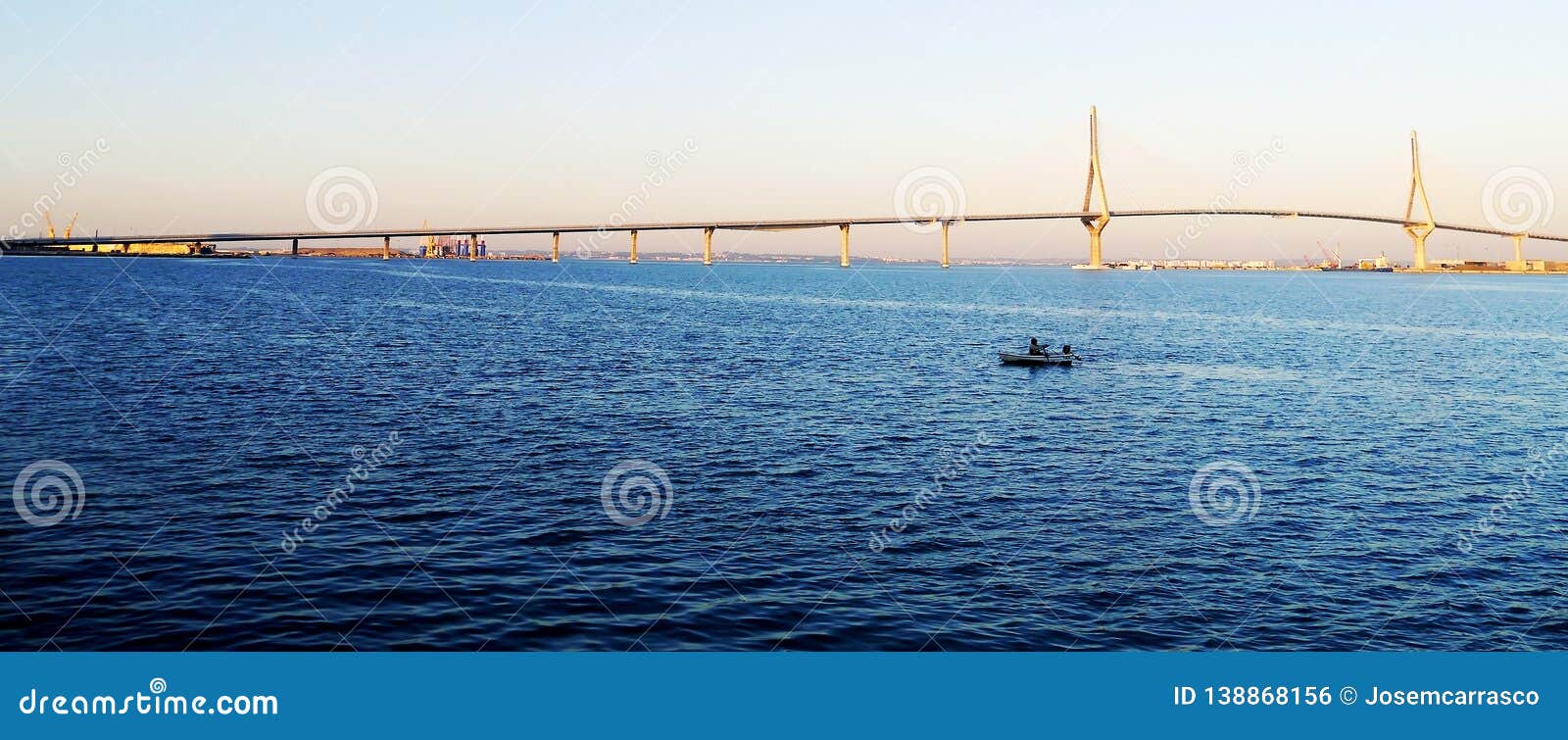 fishing boats in sunset at the puente de la constituciÃÂ³n, called la pepa, in the bay of cÃÂ¡diz, andalusia. spain