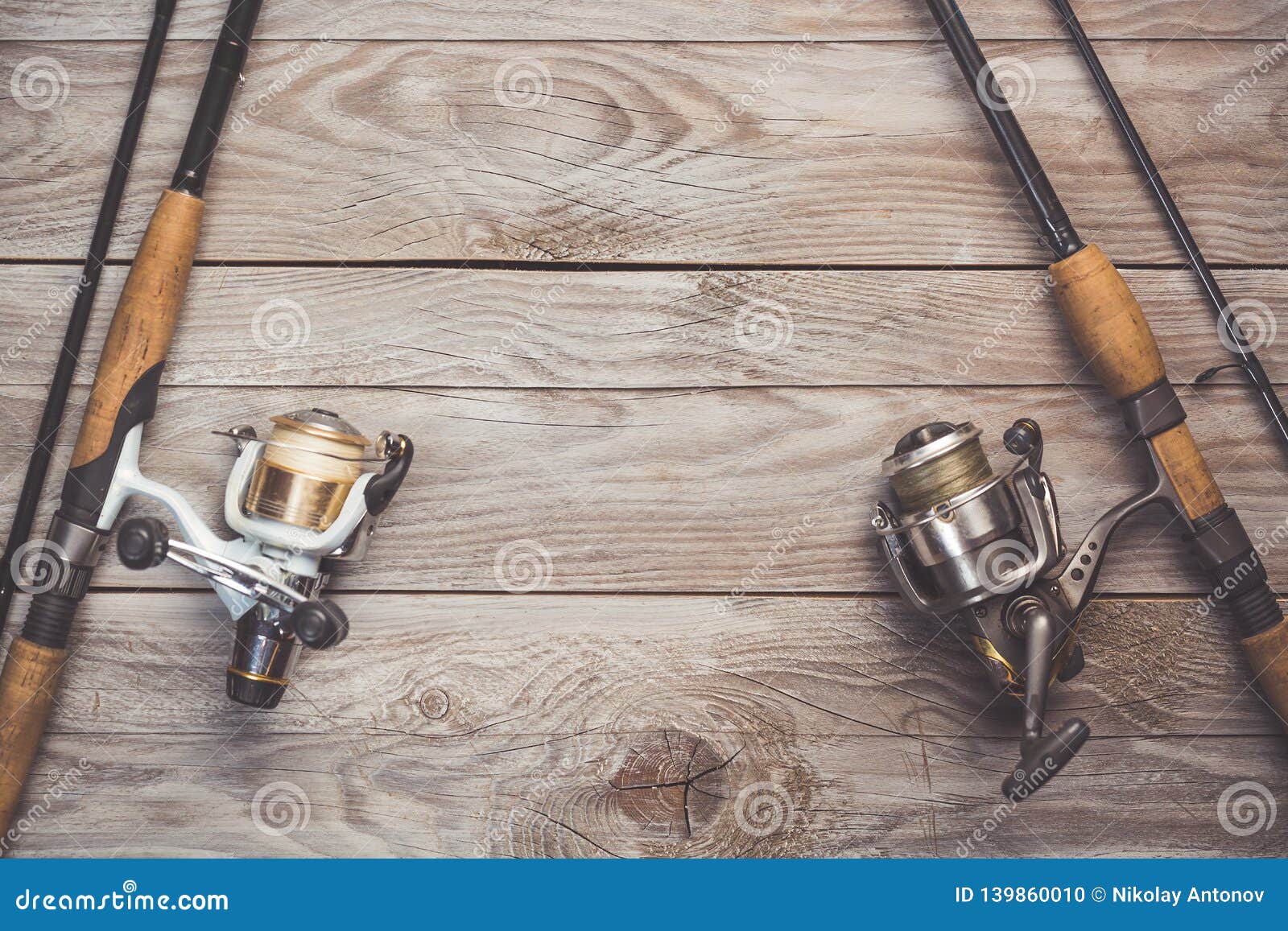 Fishing Concept. Fishing Spinning Rods and Reels with Lines on Wooden  Background with Free Space Stock Photo - Image of gear, equipment: 139860010