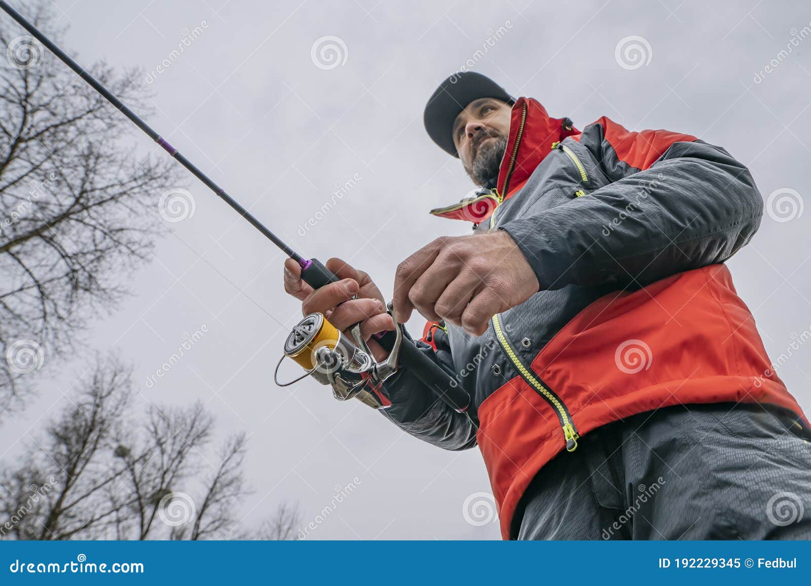 Fishing. Fisherman in Action, Man Catch Fish by Spinning Rod Stock