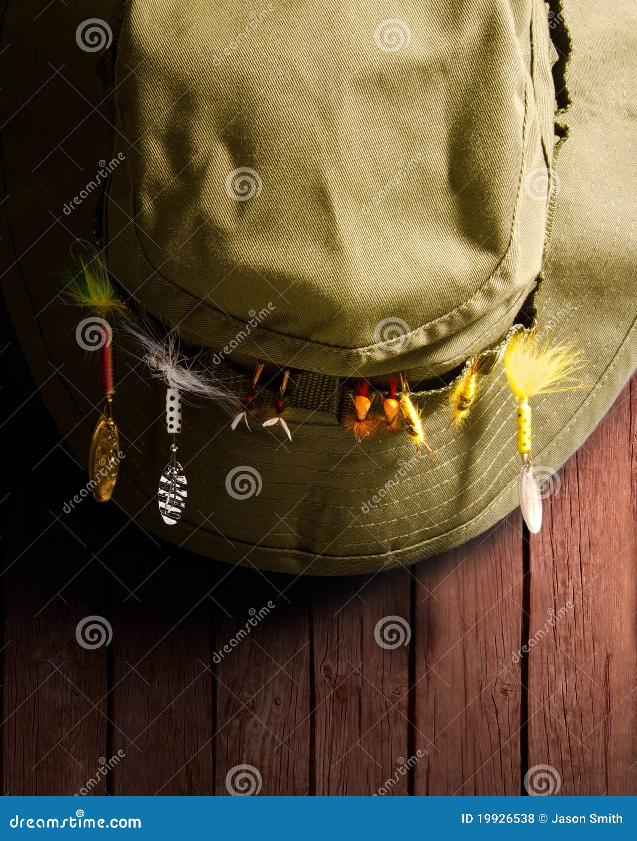 Camouflage Fishing Hat With Fishing Lures Attached Stock Photo