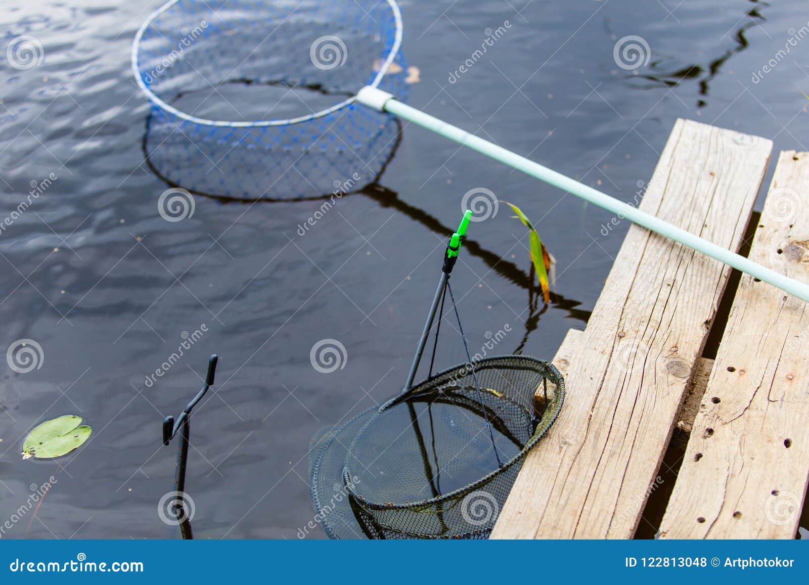 Fishing Instrument on Shore. Landing Net and Rod Holders Stock Photo -  Image of green, fishing: 122813048