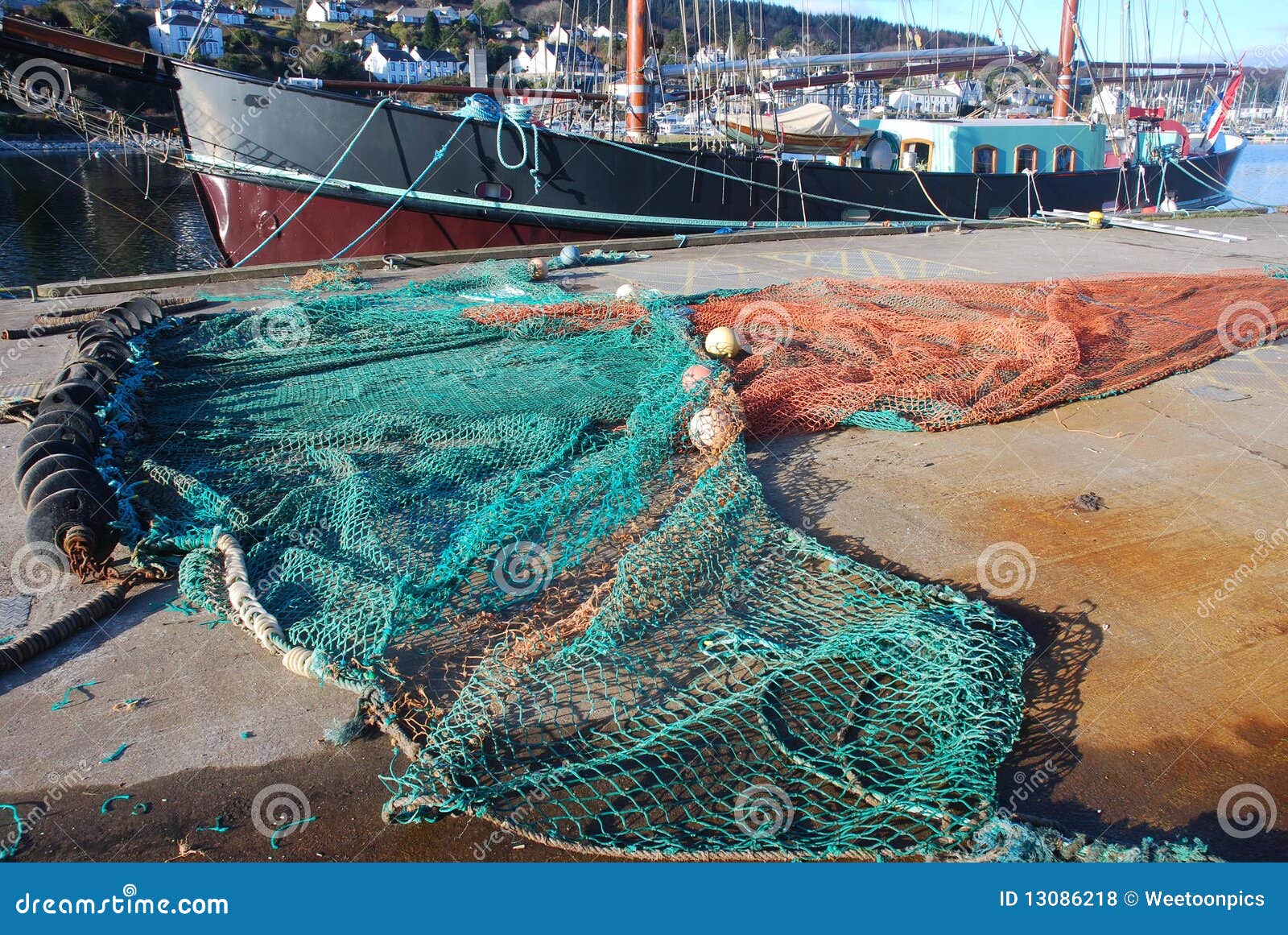Fishing nets on the back of a trawler in West Bay harbour, Dorset Stock  Photo - Alamy