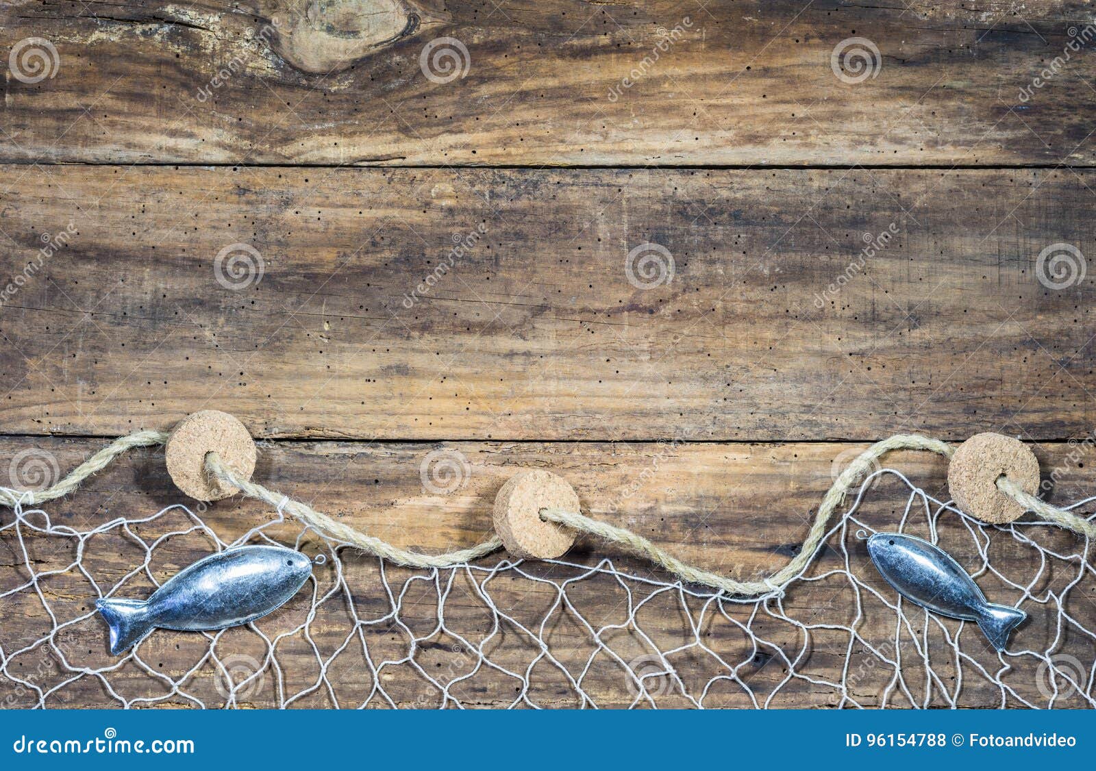 Fishing Net with Fish Decoration on Brown Wood Background Stock