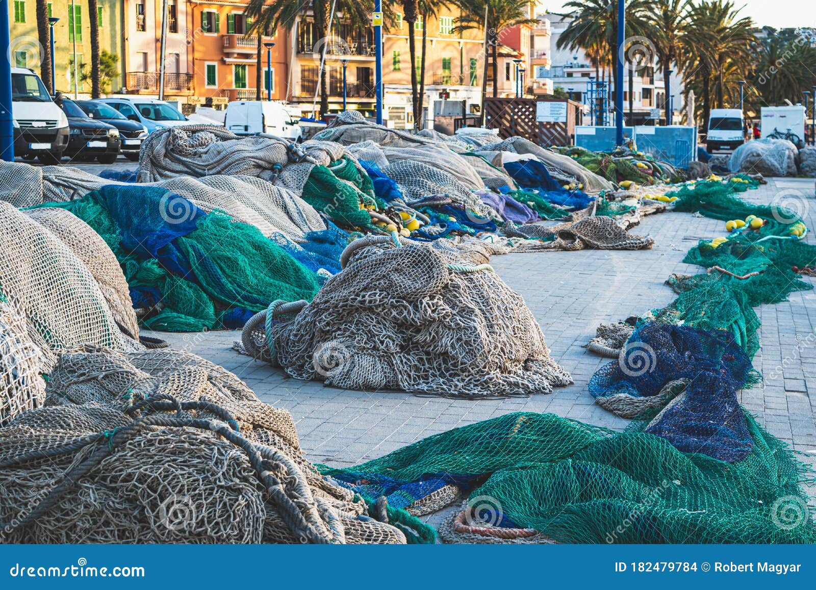 fishing nets in port blue and green color not in use stacked together for renovation