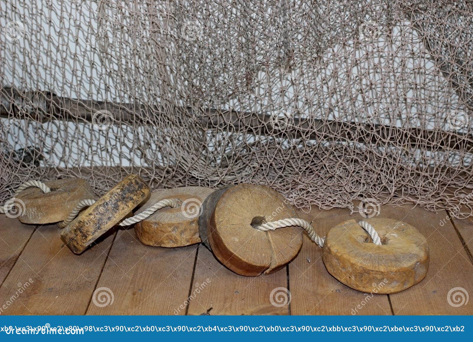 Fishing Nets with Wooden Floats on a Wooden Floor Stock Photo