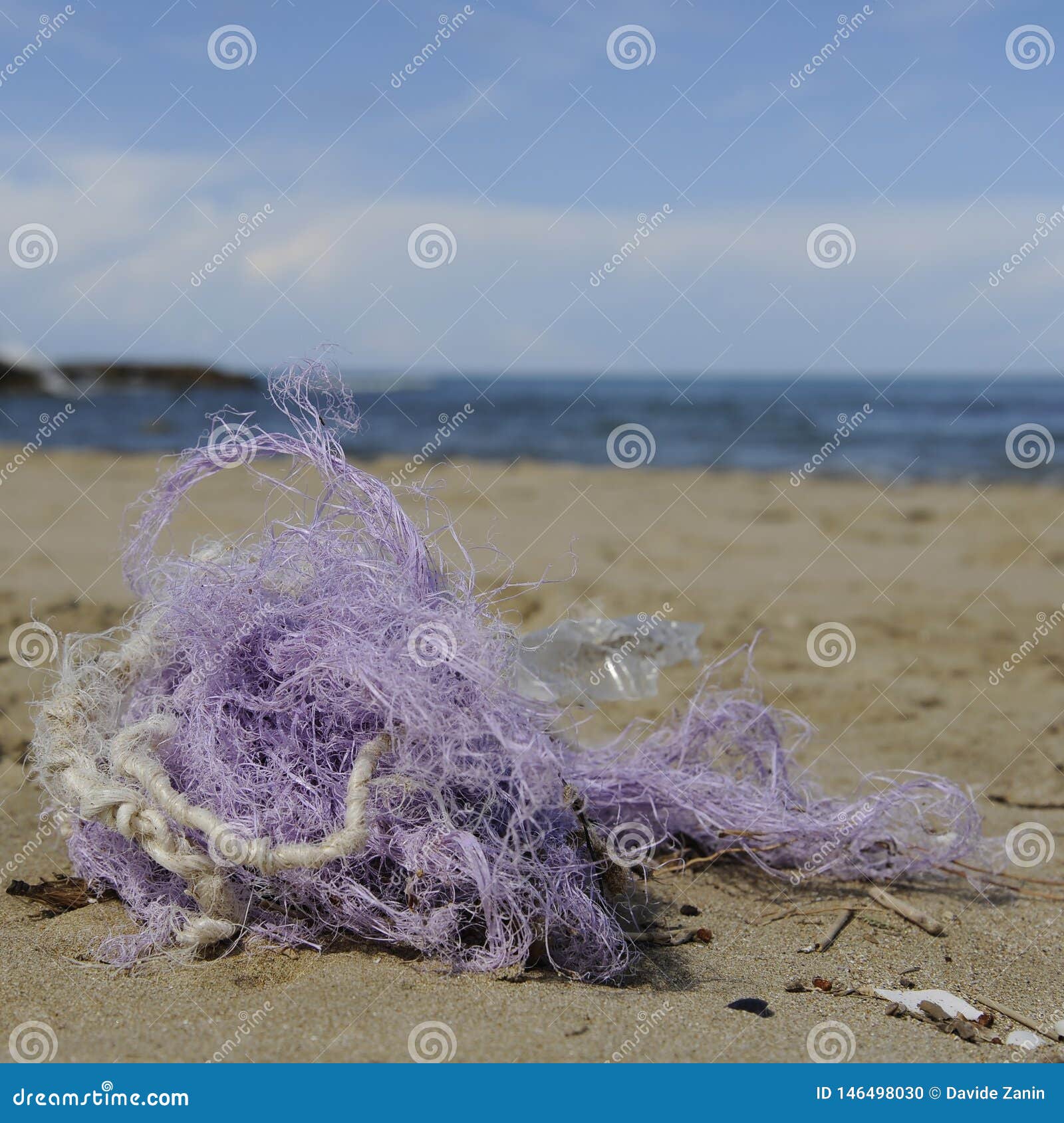 Fishing Nylon Net on the Sand. Garbage on the Beach. Dirty Sea