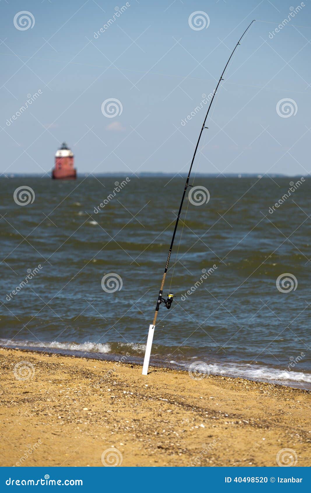 Fishing pole on the beach stock photo. Image of reel - 40498520