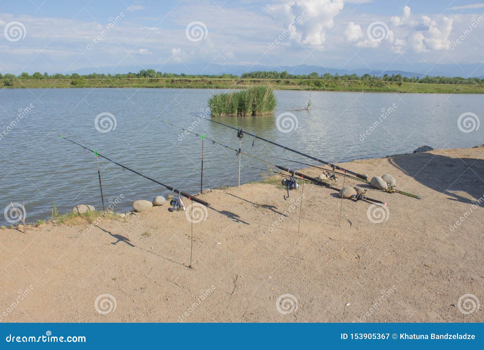 https://thumbs.dreamstime.com/z/fishing-poles-mounted-holder-set-up-shore-lake-launched-rod-waiting-153905367.jpg