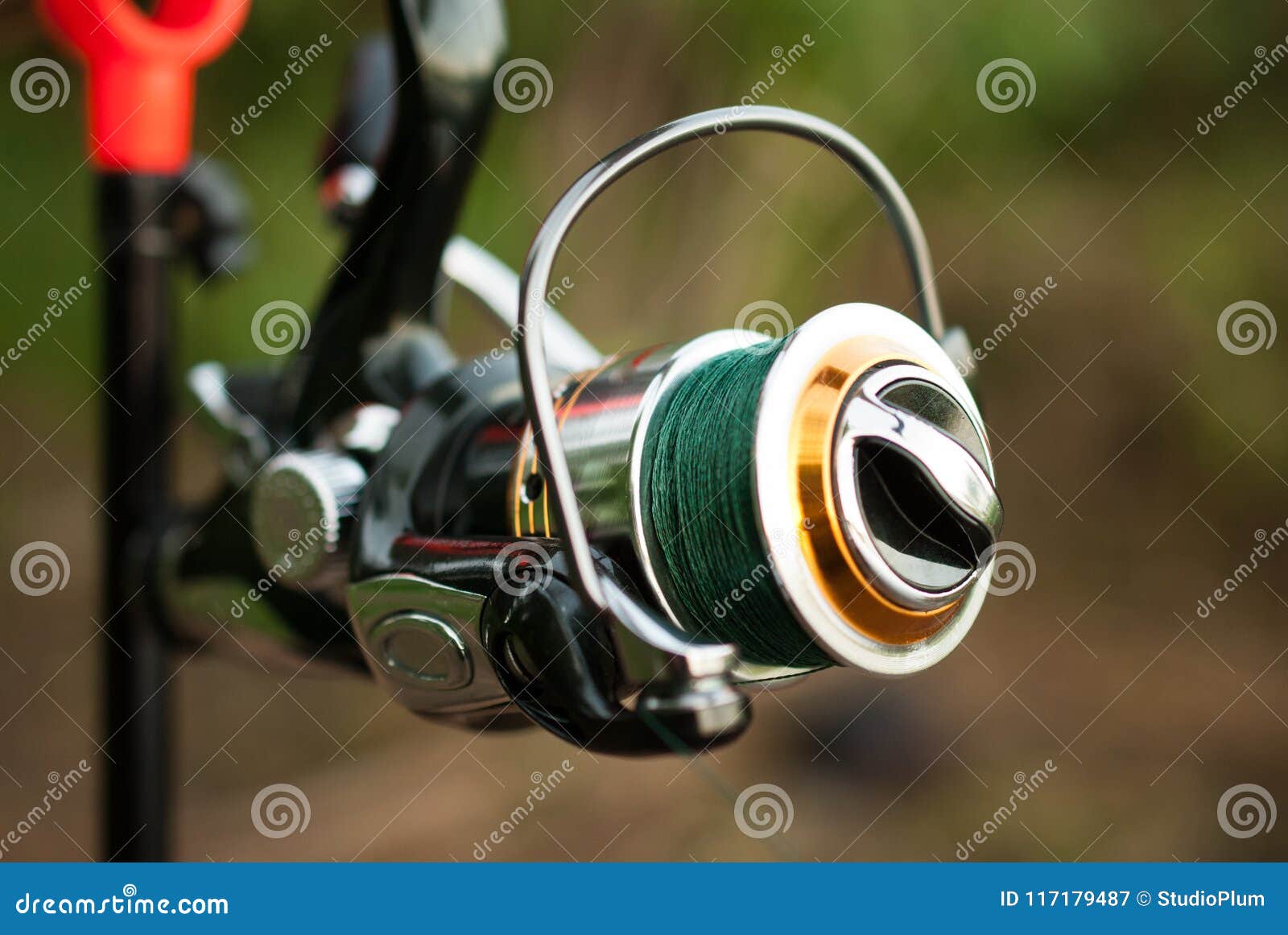 Fishing Reel on a Rod with a Woven Thread Stock Image - Image of