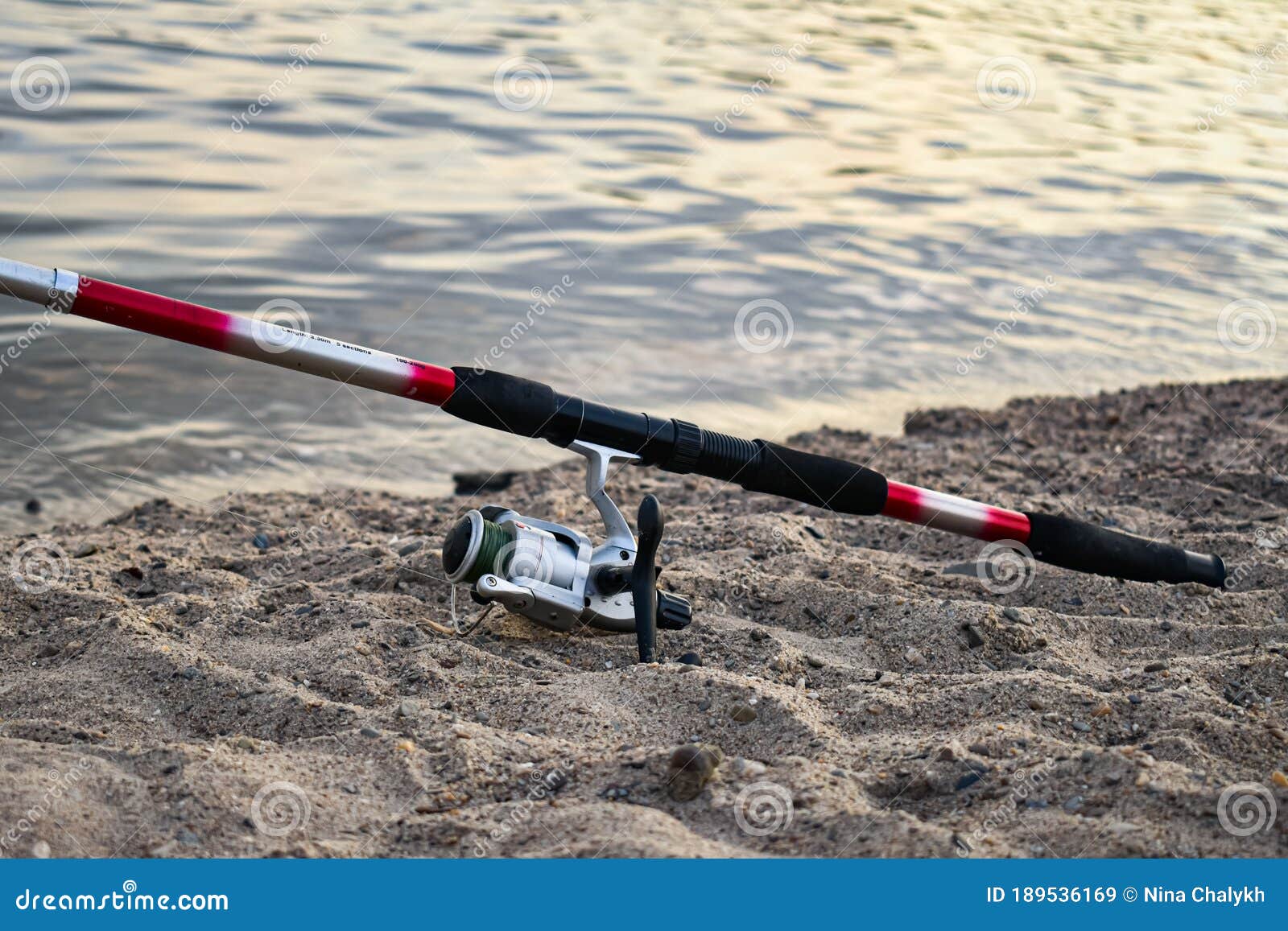 Fishing Tackle: Red-black Fishing Rod with a Reel on the Sandy Shore. Stock  Image - Image of leisure, equipment: 189536169