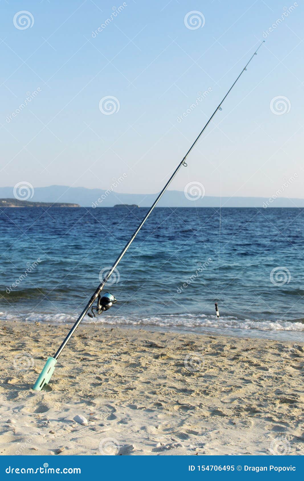 Fishing rod on beach shore stock image. Image of island 154706495