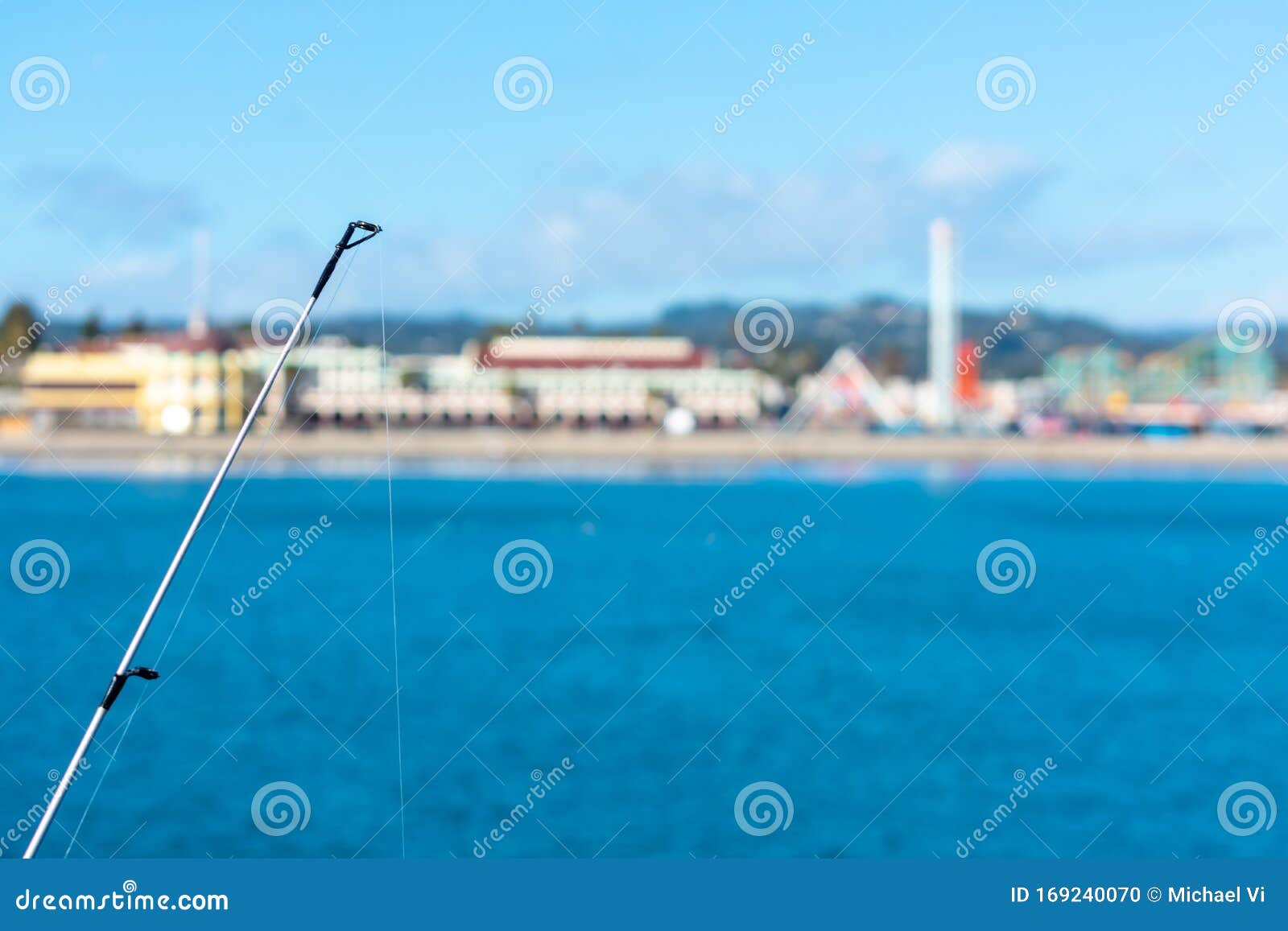 Fishing Rod with Fishing Line. Blurred Coastline on Horizon Under Blue Sky  with Clouds Stock Photo - Image of horizon, quiet: 169240070