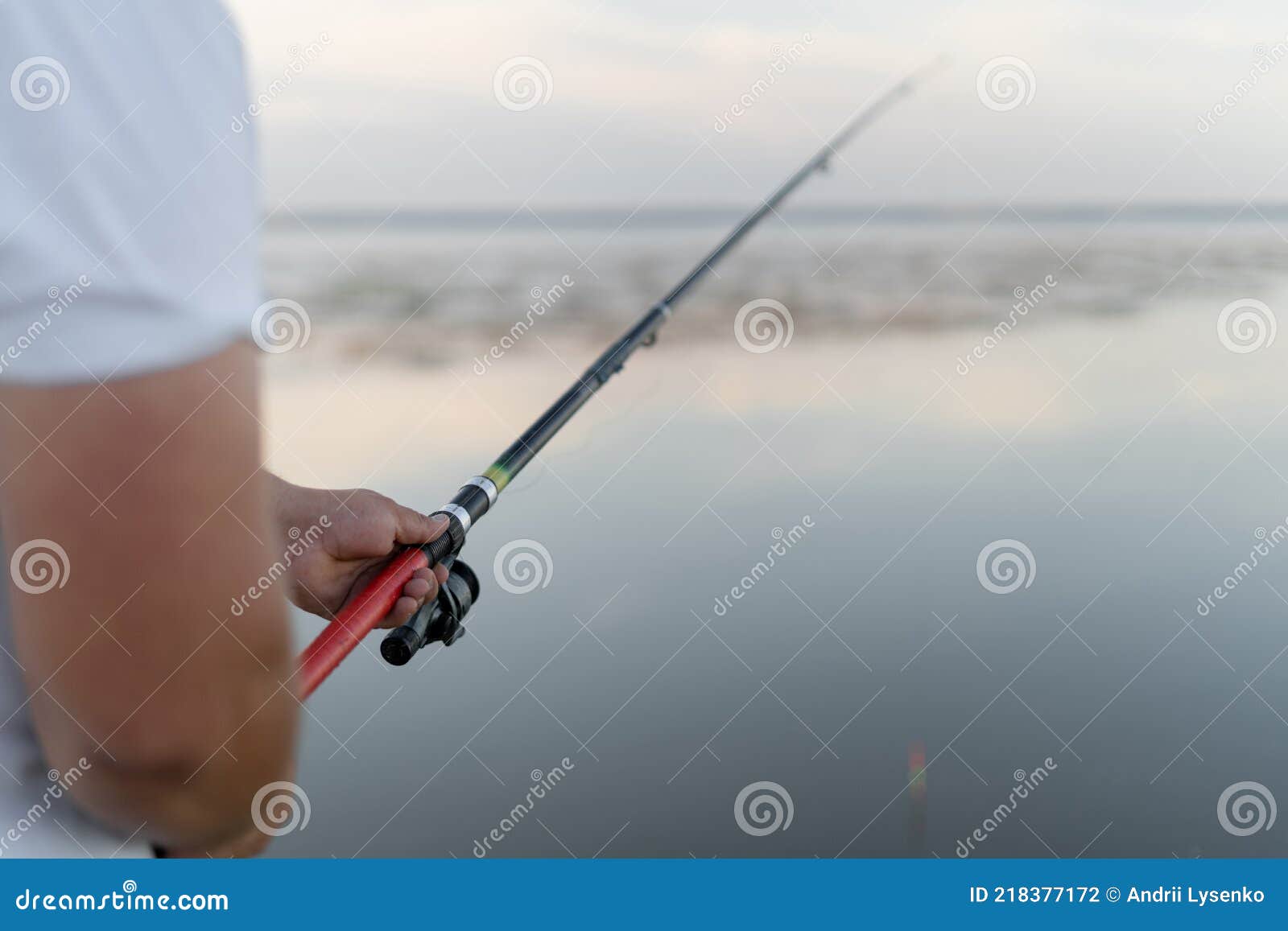 Fishing Rod with a Float in Male Hands. the Man is a Fisherman