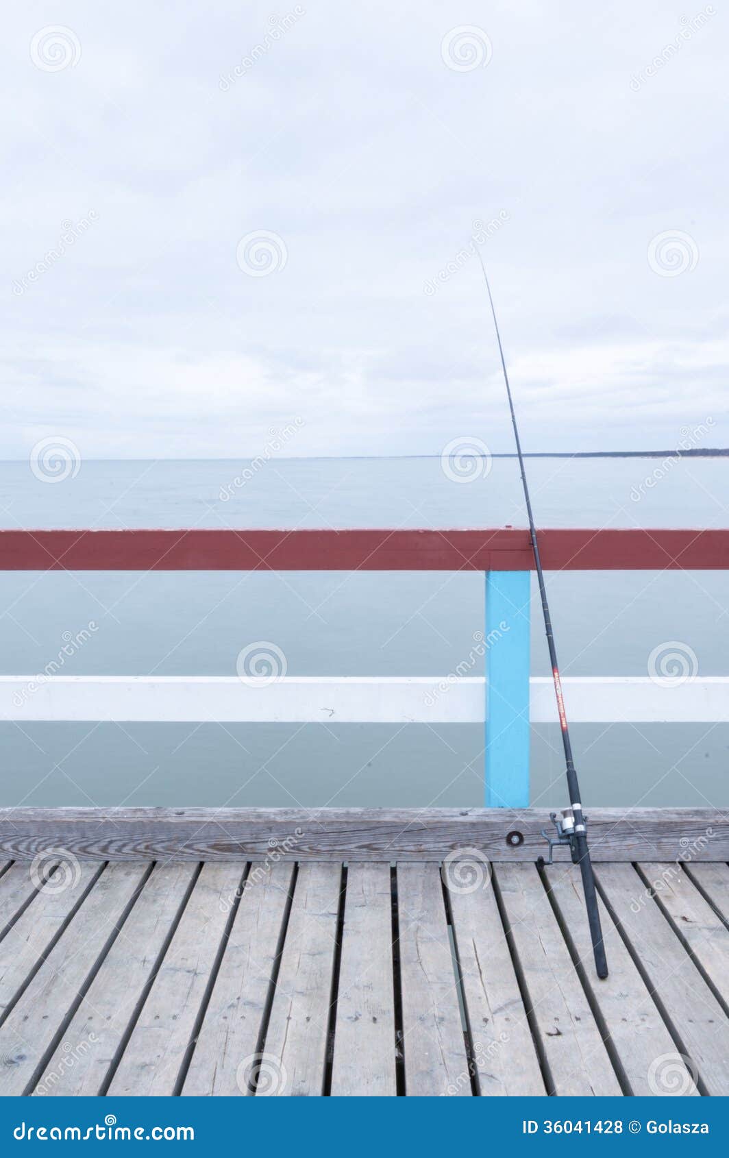Fishing rod on jetty stock photo. Image of saltwater 36041428