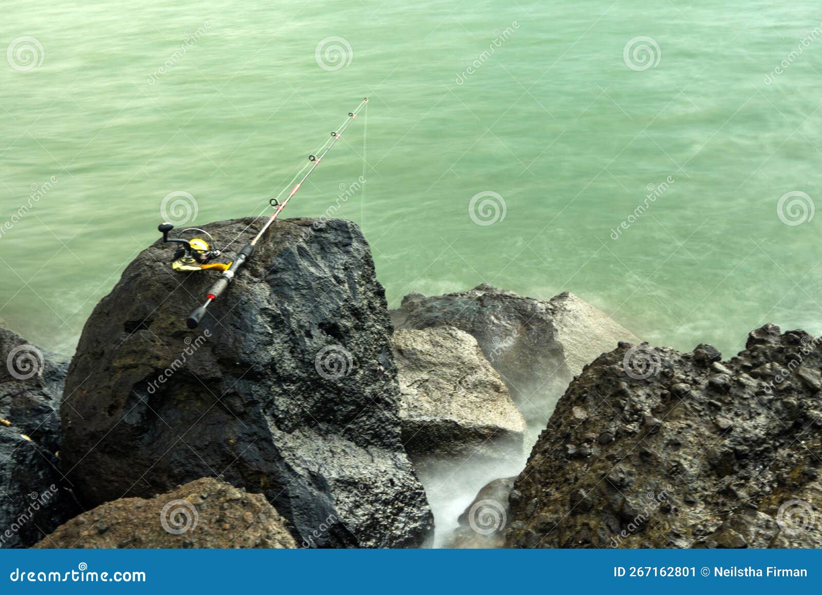 Fishing Rod Is Left On The Rock At The Marina Beach Semarang. Indonesia.  Stock Photo, Picture and Royalty Free Image. Image 197299928.