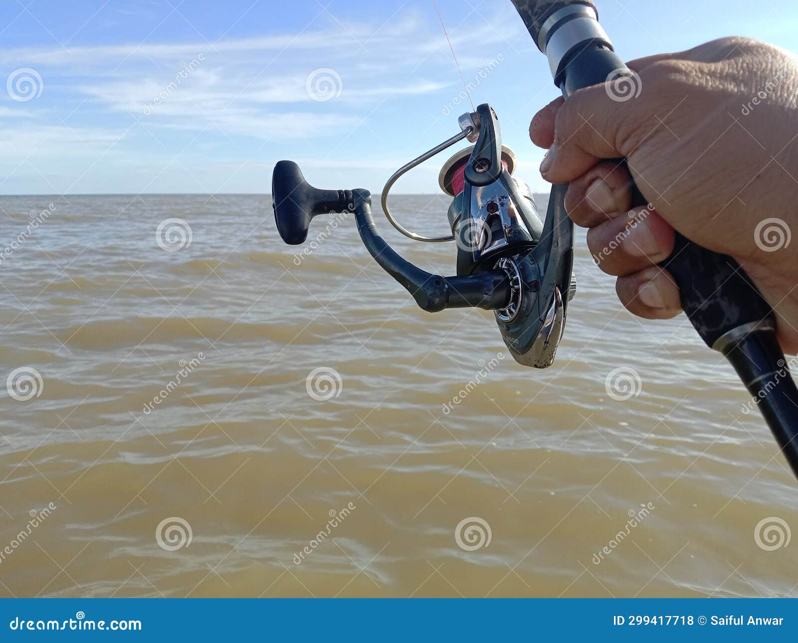 The Fishing Rod and Rail are Visible when Fishing on Sea Water Stock