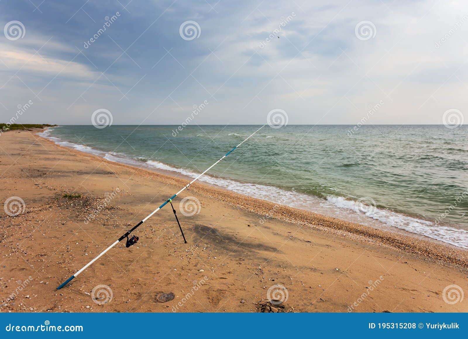 Fishing rod on a sea beach stock photo. Image of fishing 195315208