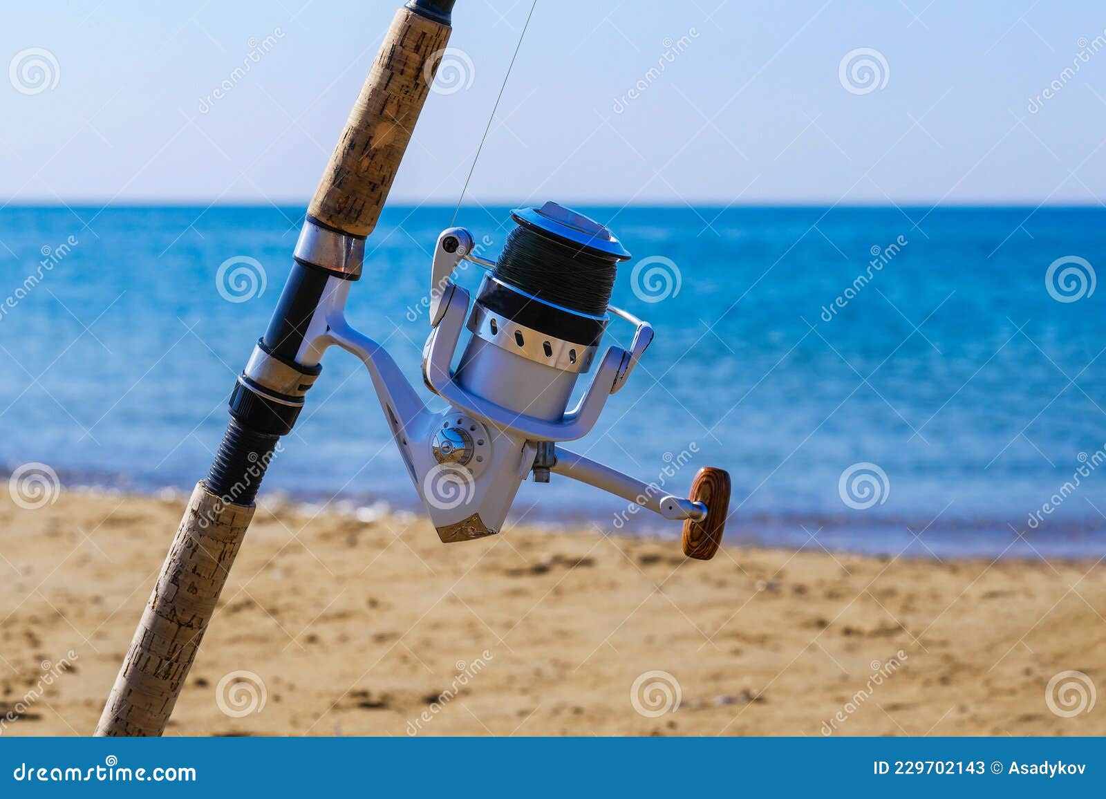 Fishing Rod with Spinning Reel on Beach. Saltwater Fishing on Sea Shore  Stock Image - Image of fish, ocean: 229702143